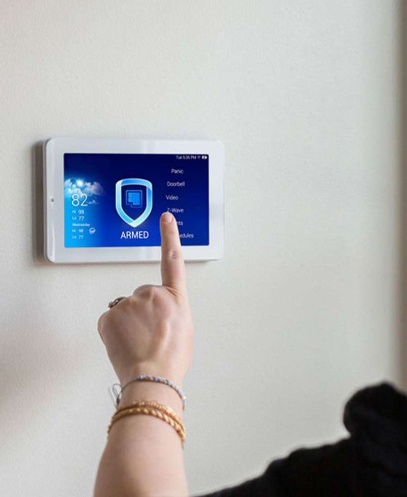 Alarm panel on a wall showing the armed status